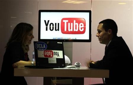 
Visitors are seen at "You Tube" stand during the MIDEM, which is the international record music publishing and video music market, in Cannes January 23, 2011. REUTERS/Eric Gaillard
