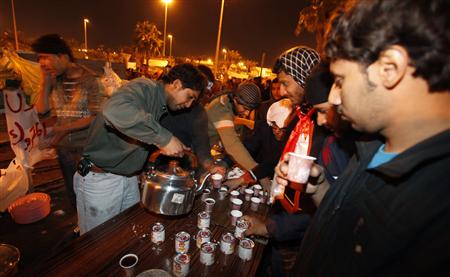 
Protesters serve coffee and tea at the Pearl Roundabout, a famous landmark of Bahrain, in the heart of its capital Manama February 15, 2011. Shi'ite protesters camped out in Bahrain's capital on Tuesday after a day of protests in which a man was shot dead in clashes with police at a funeral for a demonstrator shot the day before. REUTERS/Hamad I Mohammed
