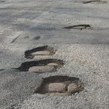 Potholes On A Road Potholes On A Road