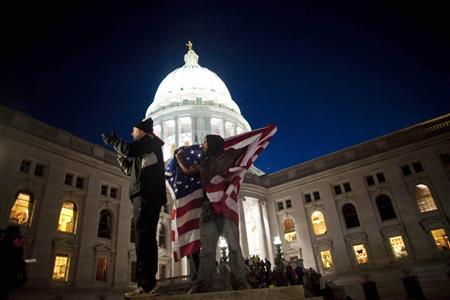 Protesters crowd the State capitol grounds as members of the Wisconsin State Government discuss a proposed bill by Republican Governor Scott Walker, in Madison February 18, 2011. The proposal by Walker to curb the bargaining rights of public unions in order to make immediate budget savings has sparked outrage among union workers in the state. REUTERS/Darren Hauck