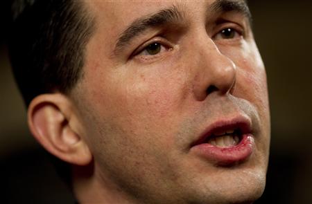 
Wisconsin Governor Scott Walker reacts in the governor conference room at the State Capital to give a fireside chat in Madison February 22, 2011. REUTERS/ Tom Lynn/ Pool
