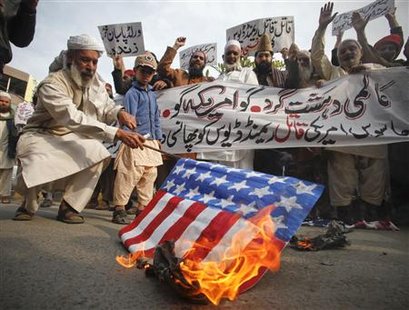 A man burns a mock U.S. flag during a rally to protest against U.S. special forces officer Raymond Davis in Lahore February 24, 2011. The placards and banner read," Hang killer U.S. spy Raymond Davis". REUTERS/Mohsin Raza
A man burns a mock U.S. flag during a rally to protest against U.S. special forces officer Raymond Davis in Lahore February 24, 2011. The placards and banner read," Hang killer U.S. spy Raymond Davis". REUTERS/Mohsin Raza