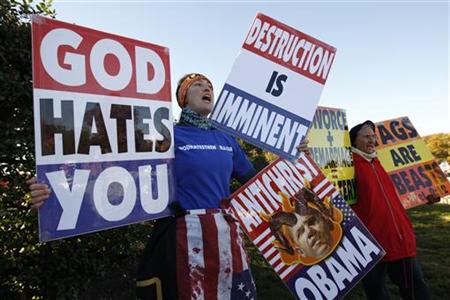 Members of the Westboro Baptist Church hold anti-gay signs at Arlington National Cemetery in Virginia on Veterans Day, November 11, 2010. The Supreme Court ruled on Wednesday that a church has the legal right to stage anti-gay protests at military funerals to promote its claim that God is angry at America for its tolerance of homosexuality. REUTERS/Kevin Lamarque
Members of the Westboro Baptist Church hold anti-gay signs at Arlington National Cemetery in Virginia on Veterans Day, November 11, 2010. The Supreme Court ruled on Wednesday that a church has the legal right to stage anti-gay protests at military funerals to promote its claim that God is angry at America for its tolerance of homosexuality. REUTERS/Kevin Lamarque