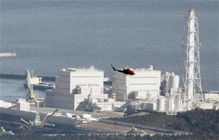 
A helicopter flies past Japan's Fukushima Daiichi No.1 Nuclear reactor March 12, 2011. REUTERS/Kim Kyung-Hoon
