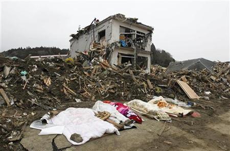The bodies of victims are covered by blankets at a village destroyed by the earthquake and tsunami in Rikuzentakata in Iwate prefecture, northeast Japan March 15, 2011. REUTERS/Lee Jae-Won
The bodies of victims are covered by blankets at a village destroyed by the earthquake and tsunami in Rikuzentakata in Iwate prefecture, northeast Japan March 15, 2011. REUTERS/Lee Jae-Won