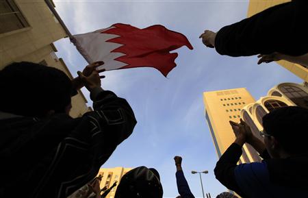 
Anti-government protesters gesture to a helicopter flying over the Saudi Embassy in Manama in this March 15, 2011 file photo. REUTERS/Hamad I Mohammed
