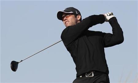 
Paul Casey of Britain tees off on the ninth hole during the first round of the Qatar Masters golf tournament in Doha February 3, 2011. REUTERS/Fadi Al-Assaad
