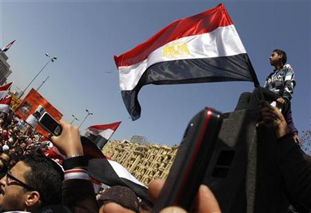People wave Egyptian flags during a pro-democracy rally at Tahrir Square, in Cairo March 4, 2011. REUTERS/Peter Andrews
People wave Egyptian flags during a pro-democracy rally at Tahrir Square, in Cairo March 4, 2011. REUTERS/Peter Andrews
