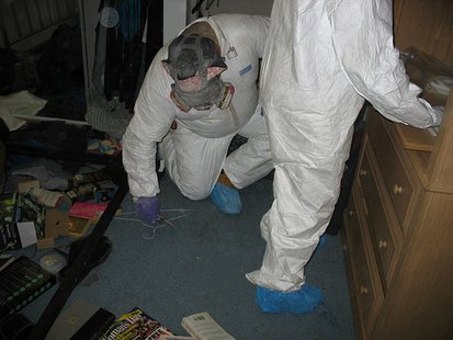 Workers wearing protective gear sample inside a residence for levels of the highly addictive drug methamphetamine Workers wearing protective gear sample inside a residence for levels of the highly addictive drug methamphetamine
