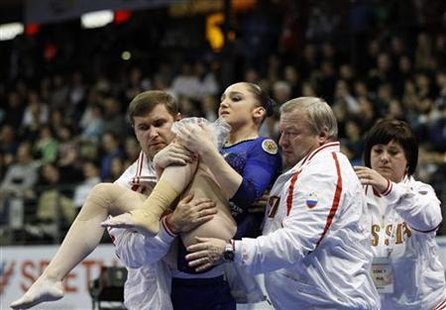 Aliya Mustafina of Russia receives assistance after falling while competing on the vault at the women's individual all-around final during the Artistic Gymnastics European Championships in Berlin, April 8, 2011. REUTERS/Tobias Schwarz
Aliya Mustafina of Russia receives assistance after falling while competing on the vault at the women's individual all-around final during the Artistic Gymnastics European Championships in Berlin, April 8, 2011. REUTERS/Tobias Schwarz