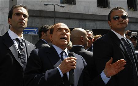 Italian Prime Minister Silvio Berlusconi gestures as he speaks to supporters outside Milan's court April 11, 2011. REUTERS/Alessandro Garofalo
Italian Prime Minister Silvio Berlusconi gestures as he speaks to supporters outside Milan's court April 11, 2011. REUTERS/Alessandro Garofalo