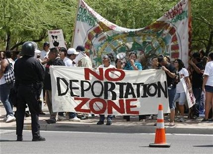Protesters, against SB 1070, hold signs up in front of the Phoenix courthouse in Phoenix, Arizona, July 29, 2010. REUTERS/Rick Scuteri
Protesters, against SB 1070, hold signs up in front of the Phoenix courthouse in Phoenix, Arizona, July 29, 2010. REUTERS/Rick Scuteri