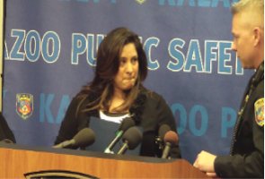 Fallen Kalamazoo Department of Public Safety Officer Eric Zapata's sister Irene Ferguson approaches the podium to deliver the families statement Tuesday as KDPS Chief Jeff Hadley looks on.  