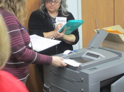 An election official puts a ballot through a counting machine during Marathon County's recount of Wisconsin's Supreme Court race An election official puts a ballot through a counting machine during Marathon County's recount of Wisconsin's Supreme Court race