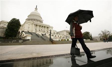 
A worker departs the U.S. Capitol April 8, 2011. REUTERS/Kevin Lamarque
