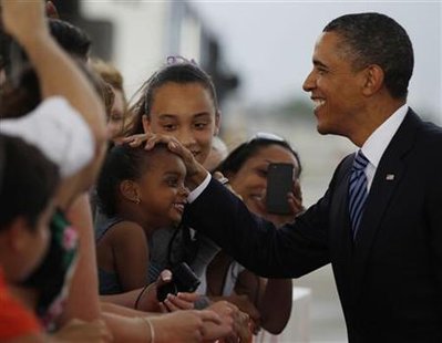 President Barack Obama greets supporters after arriving aboard Air Force One at Miami International Airport in Florida, April 29, 2011. REUTERS/Larry Downing
President Barack Obama greets supporters after arriving aboard Air Force One at Miami International Airport in Florida, April 29, 2011. REUTERS/Larry Downing