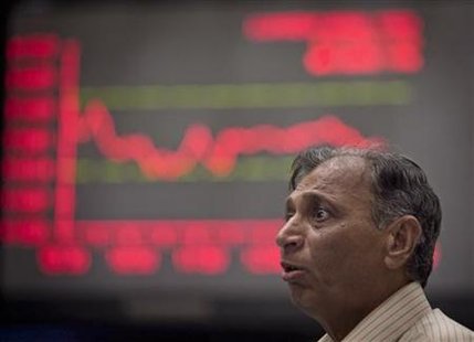 An investor reacts in front of an electronic board displaying stock prices at the Karachi Stock Exchange April 19, 2011. REUTERS/Akhtar Soomro
An investor reacts in front of an electronic board displaying stock prices at the Karachi Stock Exchange April 19, 2011. REUTERS/Akhtar Soomro