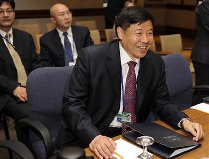 
China's Vice Finance Minister Zhu Guangyao greets photographers in Washington in this April 14, 2011 file photo. REUTERS/Mike Theiler
