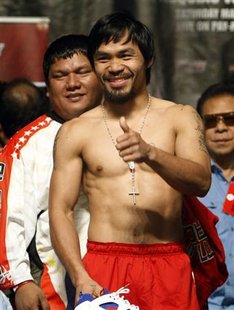 Manny Pacquiao of the Philippines gives a "thumbs-up" to a member of the audience during an official weigh-in at the MGM Grand Garden Arena in Las Vegas, Nevada May 6, 2011. Filipino trainer Buboy Fernandez is at left. REUTERS/Steve Marcus
Manny Pacquiao of the Philippines gives a "thumbs-up" to a member of the audience during an official weigh-in at the MGM Grand Garden Arena in Las Vegas, Nevada May 6, 2011. Filipino trainer Buboy Fernandez is at left. REUTERS/Steve Marcus