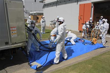Workers in protective suits connect power cables during Emergency Response Training at Fukushima Daini Nuclear Power Station Plant, about 10km away from the tsunami-crippled Daiichi plant in Fukushima, May 13, 2011, in this handout photo released by TEPCO on May 14, 2011. Mandatory Credit REUTERS/Tokyo Electric Power Co/Handout
Workers in protective suits connect power cables during Emergency Response Training at Fukushima Daini Nuclear Power Station Plant, about 10km away from the tsunami-crippled Daiichi plant in Fukushima, May 13, 2011, in this handout photo released by TEPCO on May 14, 2011. Mandatory Credit REUTERS/Tokyo Electric Power Co/Handout