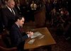 
Wisconsin State Governor Scott Walker signs the ceremonial bill, following an elimination of almost all collective bargaining for most public workers by the Republican controlled House and Senate, at the state Capitol in Madison, Wisconsin March 11, 2011. REUTERS/Darren Hauck
