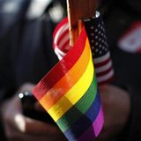 A marriage equality supporter holds gay pride and American flags at a demonstration outside the appeals hearing on California’s Proposition 8 at the 9th District Court of Appeals in San Francisco in this December 6, 2010 file photo. REUTERS/Stephen Lam
A marriage equality supporter holds gay pride and American flags at a demonstration outside the appeals hearing on California’s Proposition 8 at the 9th District Court of Appeals in San Francisco in this December 6, 2010 file photo. REUTERS/Stephen Lam