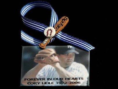 
A mourner wears a memorial pin at a reception for New York Yankees pitcher Cory Lidle, who died alongside his flight instructor last week when his plane slammed into a New York City high-rise, in Covina, California October 17, 2006. REUTERS/Lucy Nicholson
