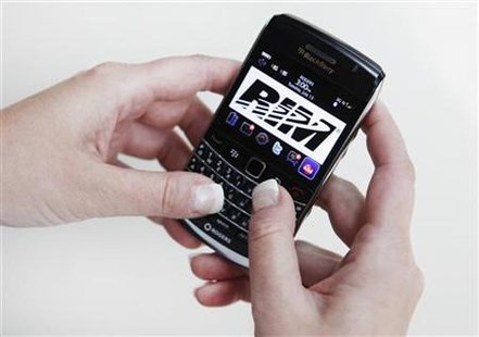 A person poses while using a Blackberry Bold 2 smartphone made by Research in Motion A person poses while using a Blackberry Bold 2 smartphone made by Research in Motion