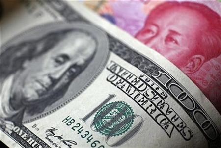 File photo of a Chinese 100 yuan banknote being placed under a $100 banknote in this photo illustration taken in Beijing File photo of a Chinese 100 yuan banknote being placed under a $100 banknote in this photo illustration taken in Beijing