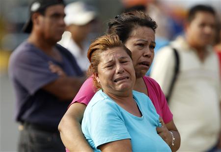Relatives of a slain man react at the crime scene in Monterrey Relatives of a slain man react at the crime scene in Monterrey