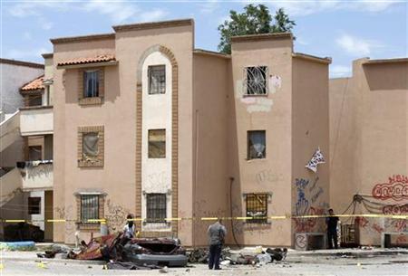 Police stand next to the body of a dead man at a crime scene in Ciudad Juarez Police stand next to the body of a dead man at a crime scene in Ciudad Juarez