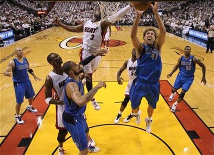 Dallas Mavericks' Nowitzki of Germany fights for a rebound with Miami Heat's Wade during the second half in Game 2 of the NBA Finals basketb Dallas Mavericks' Nowitzki of Germany fights for a rebound with Miami Heat's Wade during the second half in Game 2 of the NBA Finals basketb