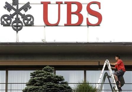 A worker climbs on a ladder under the logo of Swiss bank UBS at the company's headquarters in Zurich A worker climbs on a ladder under the logo of Swiss bank UBS at the company's headquarters in Zurich