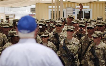 A soldier raises his hand to ask a question to U.S. Secretary of Defense Robert Gates at FOB Walton in Afghanistan A soldier raises his hand to ask a question to U.S. Secretary of Defense Robert Gates at FOB Walton in Afghanistan