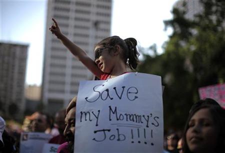 A girl protests about her mother being laid off during a rally against education budget cuts in Los Angeles A girl protests about her mother being laid off during a rally against education budget cuts in Los Angeles