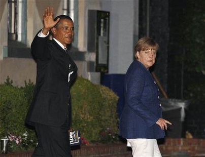 President Barack Obama walks out of restaurant with German Chancellor Angela Merkel in Washington