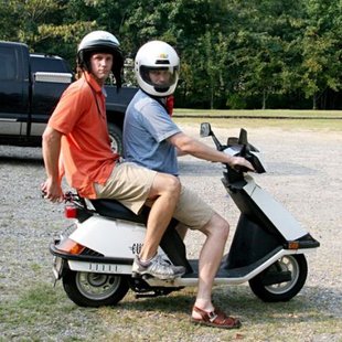 people riding a Moped people riding a Moped