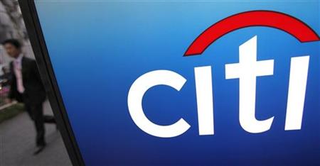 A pedestrian passes a logo of Citigroup in Tokyo A pedestrian passes a logo of Citigroup in Tokyo