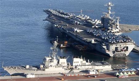 The U.S. nuclear-powered aircraft carrier USS George Washington and the Arleigh Burke-class guided-missile destroyer USS McCampbell anchor a The U.S. nuclear-powered aircraft carrier USS George Washington and the Arleigh Burke-class guided-missile destroyer USS McCampbell anchor a