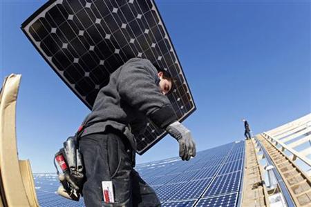 Workers install solar panels at a farm Workers install solar panels at a farm