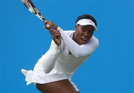 Venus Williams returns a shot from Germany's Andrea Petkovic during the 
