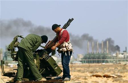 Rebel fighters fix their mounted anti-aircraft gun near the oil refinery at Ras Lanuf in Libya Rebel fighters fix their mounted anti-aircraft gun near the oil refinery at Ras Lanuf in Libya