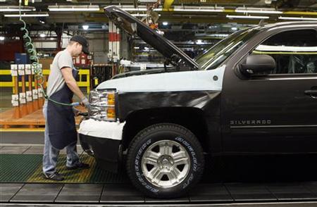 A General Motors auto assembly worker works on assembling a Chevrolet Silverado pickup truck at the Flint Assembly in Flint, Michigan A General Motors auto assembly worker works on assembling a Chevrolet Silverado pickup truck at the Flint Assembly in Flint, Michigan