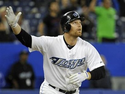Blue Jays' Lind watches his walk-off home run to beat the Orioles during their MLB American League baseball game in Toronto