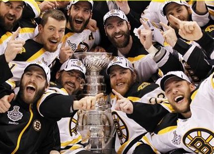 Bruins players celebrate with the Stanley Cup after they defeated the Canucks to win the NHL championship in Game 7 of the finals in Vancouv Bruins players celebrate with the Stanley Cup after they defeated the Canucks to win the NHL championship in Game 7 of the finals in Vancouv