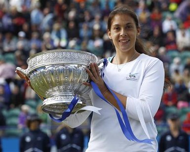 France's Marion Bartoli celebrates with the trophy after beating Czech Republic's Petra Kvitova to win the International Women's Open tennis France's Marion Bartoli celebrates with the trophy after beating Czech Republic's Petra Kvitova to win the International Women's Open tennis