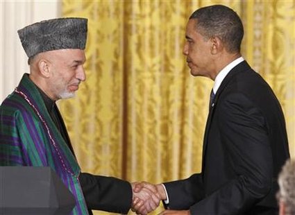 President Obama and Afghan President Karzai shake hands after a joint news conference in the East Room at the White House in Washington