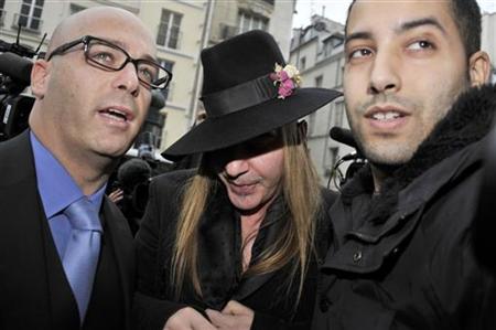 Fashion designer Galliano and his lawyer Zerbib arrive for a hearing at a police station in Paris Fashion designer Galliano and his lawyer Zerbib arrive for a hearing at a police station in Paris
