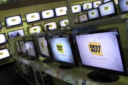 A man walks past televisions for sale at a Best Buy store in New York A man walks past televisions for sale at a Best Buy store in New York