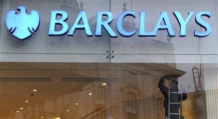 A worker carries out maintenance in a branch of Barclays bank in London